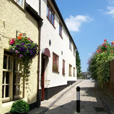 a building with flower boxes on the side of it at Frog Cottage, Ludlow - a charming townhouse for 4 in Ludlow