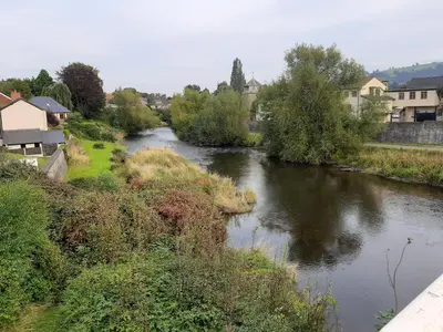 a river in a town with houses and trees at Georgian Terrace Town House in Mid Wales in Newtown