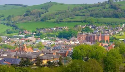 a small town in the middle of a green hill at Georgian Terrace Town House in Mid Wales in Newtown