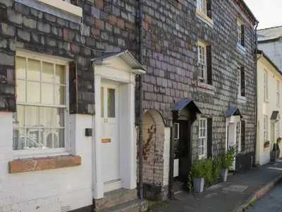 an old brick house with a white door and windows at Georgian Terrace Town House in Mid Wales in Newtown