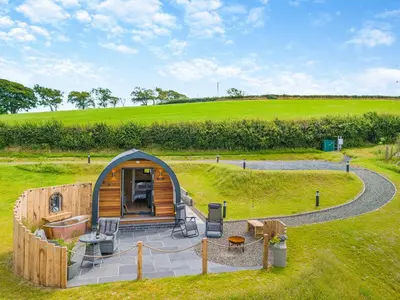 a cabin in the middle of a grassy field at Leri - Uk46065 in Llancynfelyn