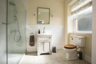 a bathroom with a shower and a toilet and a sink at Haulfryn in Barmouth