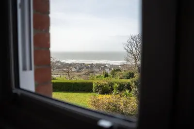 a view of the ocean from a window at Haulfryn in Barmouth