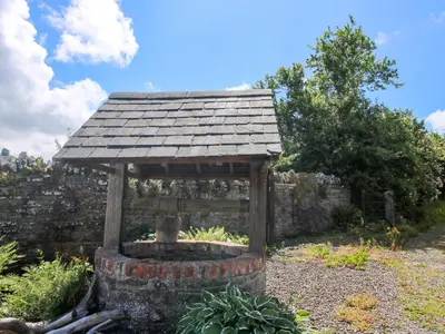 a gazebo in the middle of a garden at The Mytton at Mill Barn in Craven Arms
