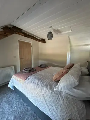 a bedroom with a large bed in a room at Cosy countryside cottage in Aberystwyth