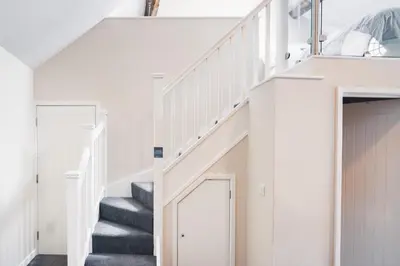 a staircase in a house with white walls and white stairs at Sunday School House in Shrewsbury
