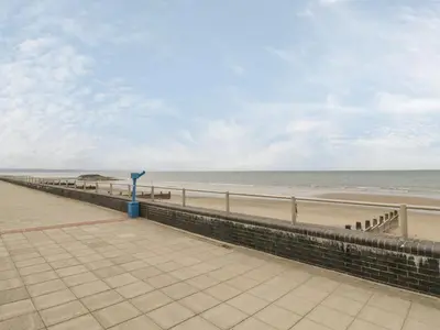 a boardwalk leading to a beach with the ocean at Tarrenhendre Pod in Tywyn