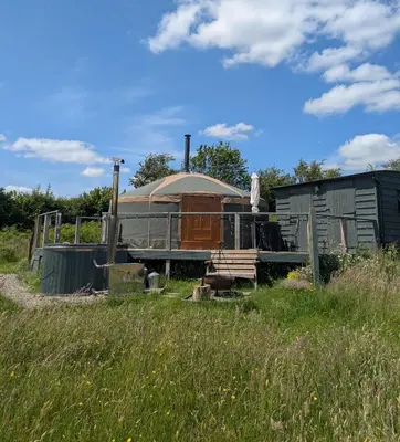 a train sitting in a field of grass at Go Eco Glamping in Lampeter