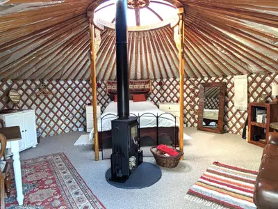 a room with a stove in a yurt at Go Eco Glamping in Lampeter