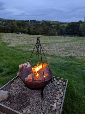 a fire pit with a fire at Go Eco Glamping in Lampeter