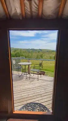 a view of a deck with a table and chairs at Go Eco Glamping in Lampeter