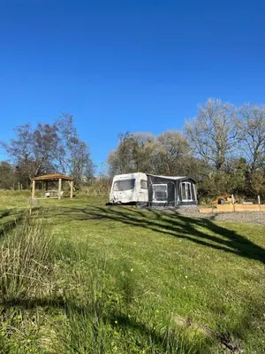 a parked van in a field of grass at Pantyronen tourer holidays in Llanbadarn-fynydd