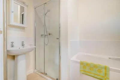 a white bathroom with a shower and a sink at 1 Bed in Hay-on-Wye oc-c29788 in Hay-on-Wye