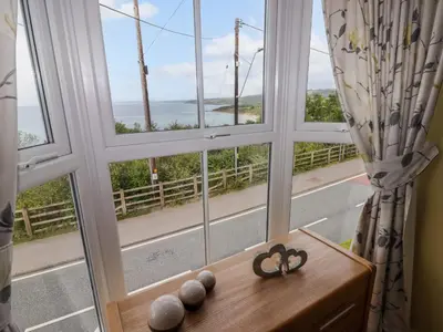 a room with a window with a view of the ocean at Morva in New Quay