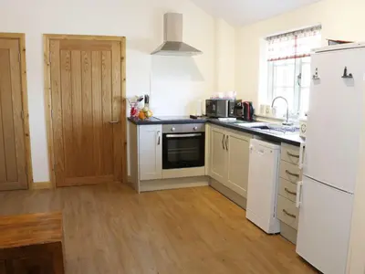 a kitchen with white appliances and a white refrigerator at Ramblers in Newtown