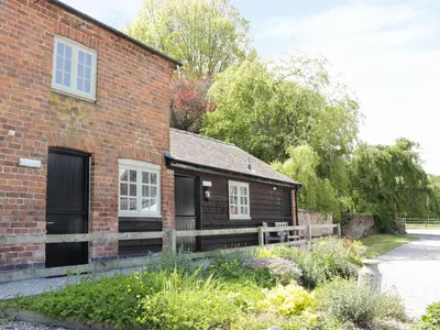 a brick house with a fence next to it at Ramblers in Newtown