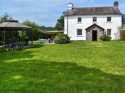 a large white house with a gazebo in a yard at Pengarreg Fawr- Uk47774 in Llanilar