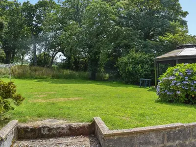 a grassy yard with a gazebo in a park at Pengarreg Fawr- Uk47774 in Llanilar