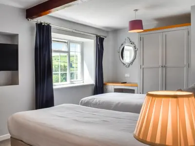 a bedroom with two beds and a window at Pengarreg Fawr- Uk47774 in Llanilar