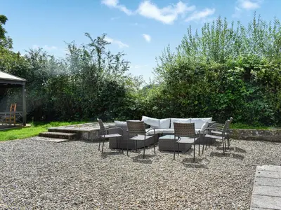 a group of chairs and a table in a yard at Pengarreg Fawr- Uk47774 in Llanilar