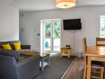a living room with a couch and a table at Cottage 1- Uk47770 in Llanilar