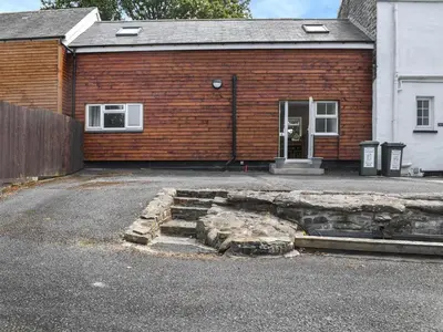 a brick building with a door and stairs in front of it at Cottage 1- Uk47770 in Llanilar