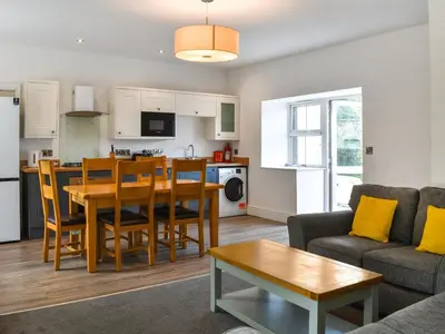a kitchen and living room with a table and a dining room at Cottage 1- Uk47770 in Llanilar