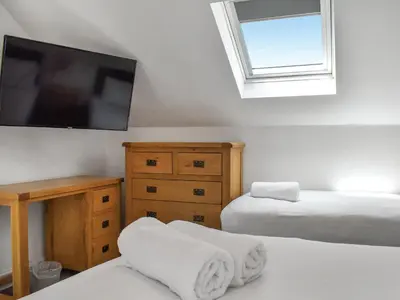 a bedroom with two beds and a flat screen tv at Cottage 1- Uk47770 in Llanilar