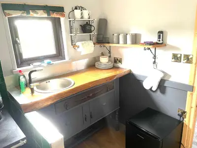 a bathroom with a sink and a window at Acorn Warren in Welshpool