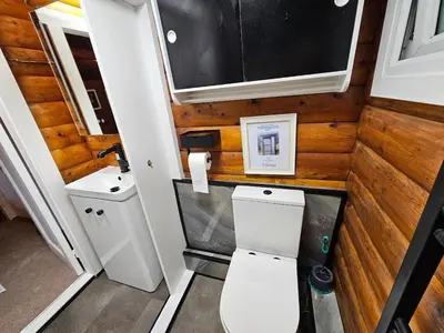 a small bathroom with a toilet and a sink at Bryn Cnocell in Trawsfynydd
