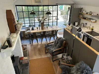 a kitchen and dining room with a table and chairs at The Hat Works in Ludlow