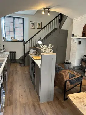 a kitchen with a counter and a staircase in a room at The Hat Works in Ludlow