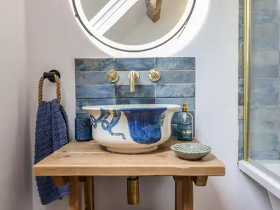 a bowl on a table in a bathroom with a mirror at Pengarreg in Barmouth