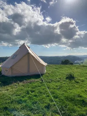 a white tent sitting in a field of grass at Fair View Bell Tent in Oswestry