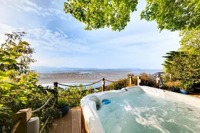 a hot tub with a view of the beach at 5 Bed in Aberdovey oc-t29402 in Aberdyfi