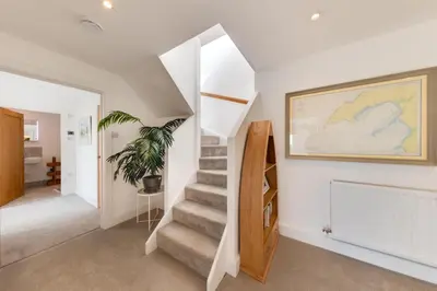 a staircase in a house with a painting on the wall at 5 Bed in Aberdovey oc-t29402 in Aberdyfi