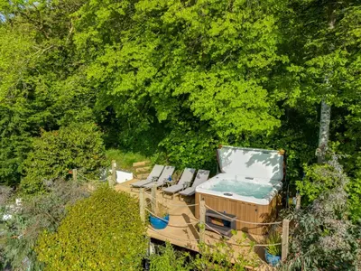 a group of chairs sitting on a deck with trees at 5 Bed in Aberdovey oc-t29402 in Aberdyfi