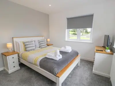 a bedroom with a bed with towels on it at Melin Y Plas in Barmouth