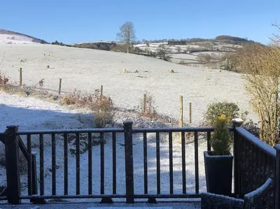 a fence with a view of a hill with animals at 5f Stanley Lodge, Caer Beris, Builth Wells - No tradesman in Builth Wells