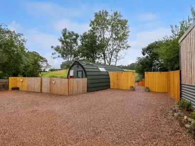 a backyard with a fence and a shed at Heron Pod in Oswestry