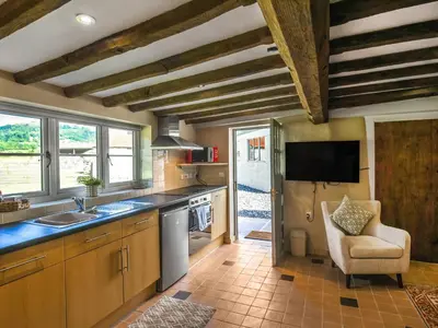 a kitchen with a sink and a counter top at Ty-Ucha Cottage in Llangollen