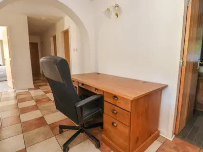 a desk with a black chair and a wooden desk at The Willows in Llangollen