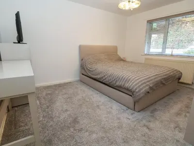 a small bedroom with a bed and a desk at The Willows in Llangollen