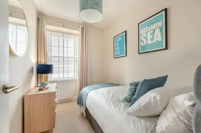 a bedroom with a bed and a table with a lamp at 3 Bed in New Quay oc-c29640 in New Quay