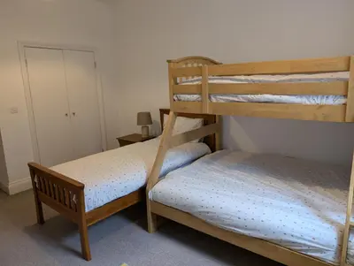 a bedroom with two bunk beds in a room at 2 Chapel Nazareth in Penrhyndeudreath