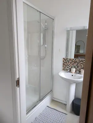a bathroom with a shower and a sink at 2 Chapel Nazareth in Penrhyndeudreath