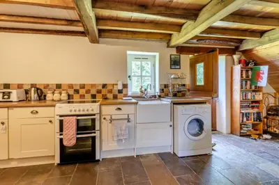 a kitchen with a washer and dryer at 1 Bed in Llwynygroes oc-y29714 in Llangeitho
