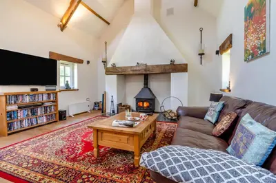 a living room with a couch and a fireplace at 1 Bed in Llwynygroes oc-y29714 in Llangeitho