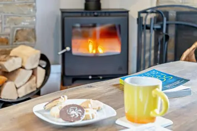 a table with a plate of pastries and a cup of coffee at 2 Bed in Crugybar oc-t29740 in Rhandirmwyn