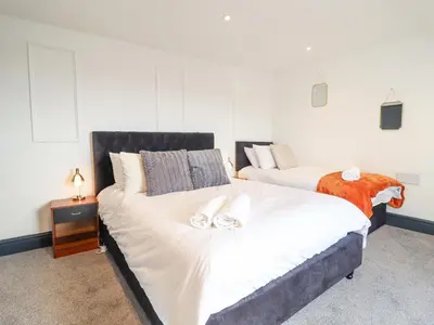 a bedroom with two beds with towels on them at Gwynfa in Barmouth